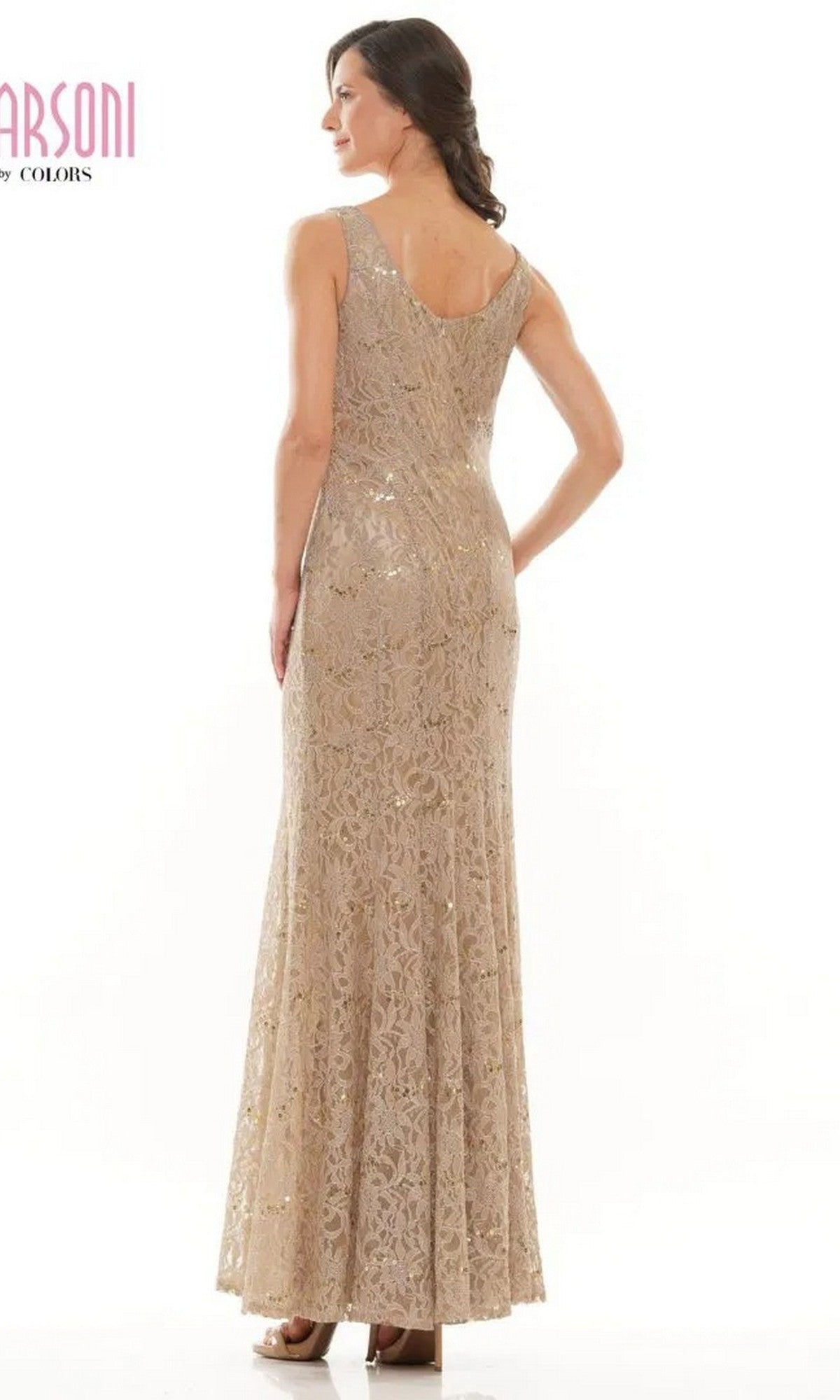 A woman faces away, wearing the Marsoni M301, a sleeveless floor-length beige formal dress with lace and a subtle shimmer.
